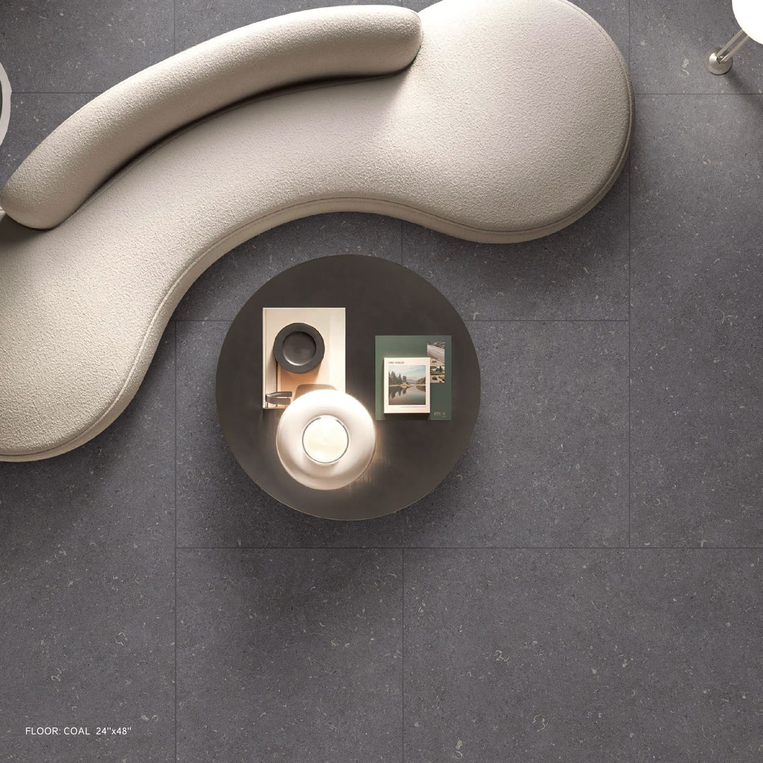 LIMESTONE Coal floor with sculptural sofa, seen from above